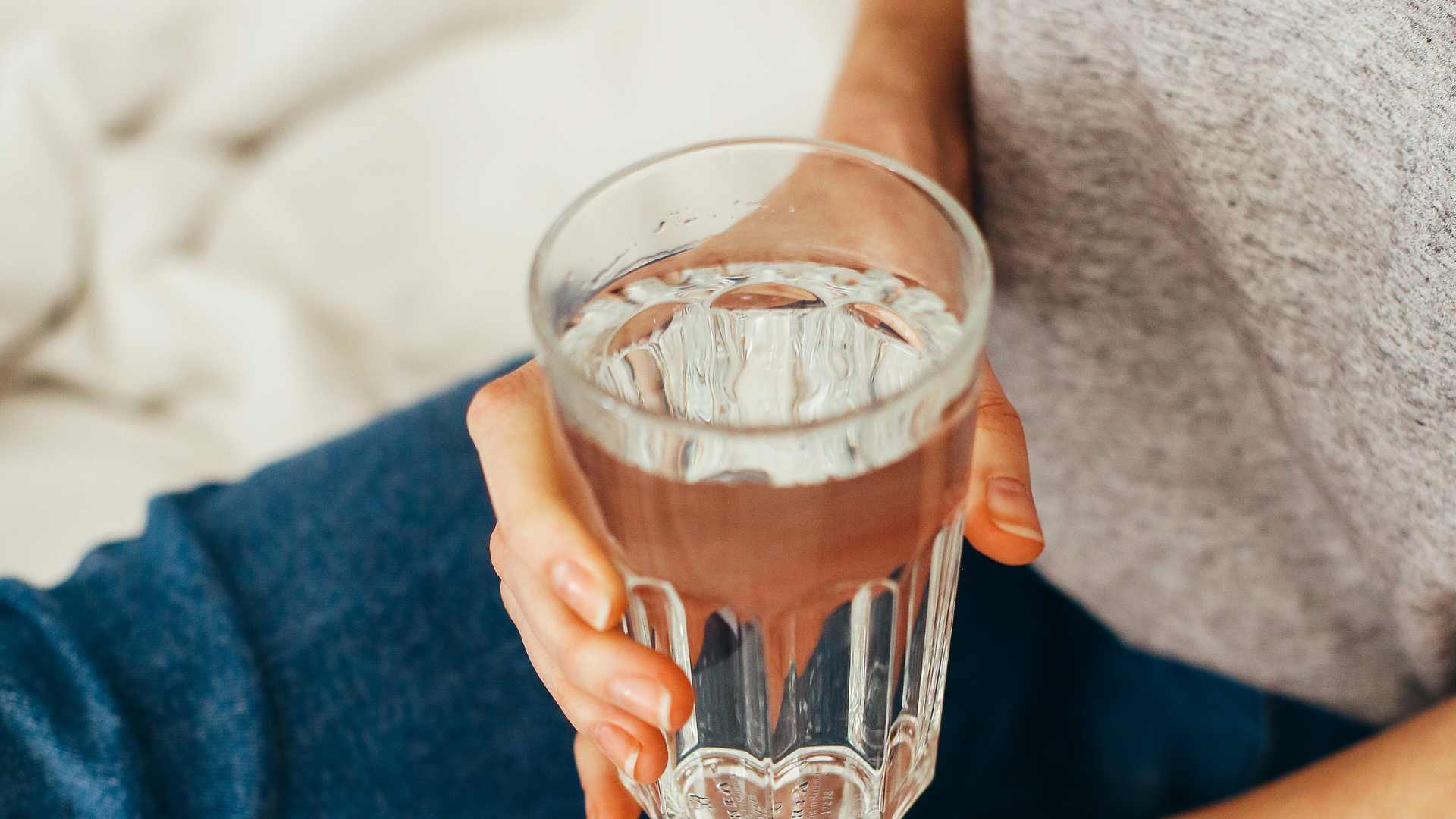 verre d'eau dans la main d'une femme